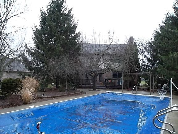 With mature trees there is plenty of privacy at the pool and wood deck areas.