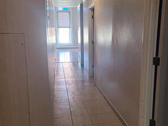 inside unit 
bank of built-in closets to the left 
living room in the distance