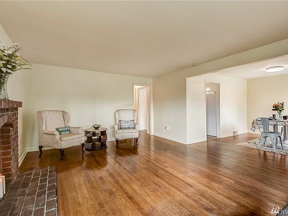 Living room flows into the dining room.  Imagine enough room to open up the table and have room for 12 around the dinner table.  Down the hallway lies the Bathroom, Master Bedroom and other mainfloor bedroom.  