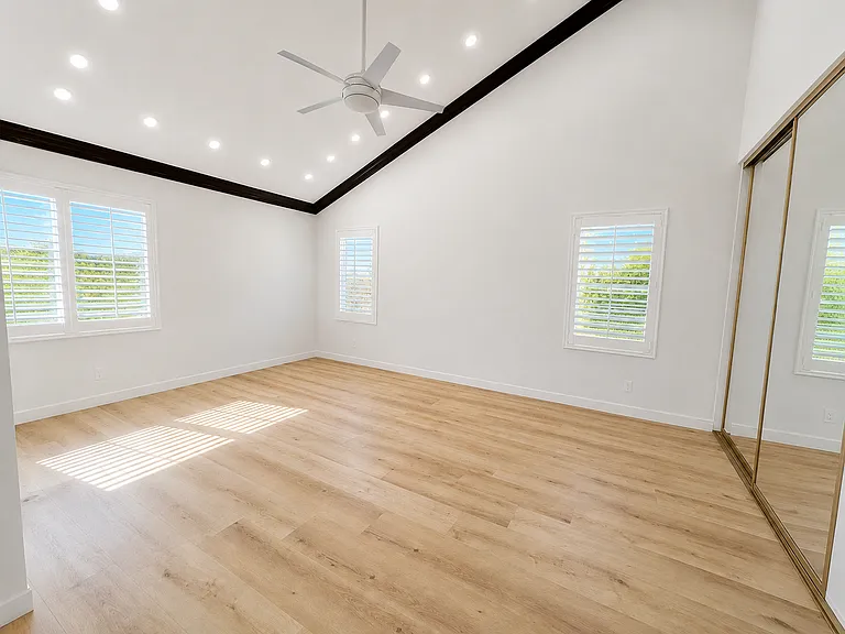 Spacious upstairs master bedroom with vaulted ceiling and recessed lights