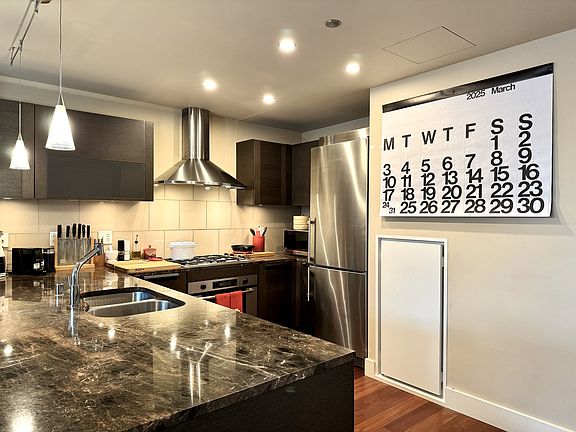 Spacious kitchen with granite countertops, high-end Bosch and Liebherr appliances, and Kohler fixtures