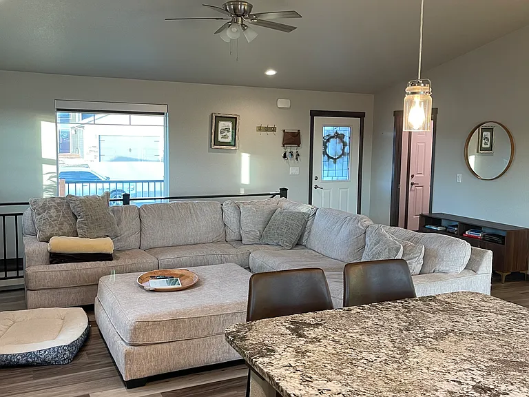 Living room with front door pictured in the back