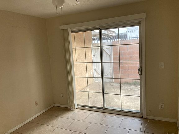 1 Bed room witH slider to private back patio and ceiling fan.