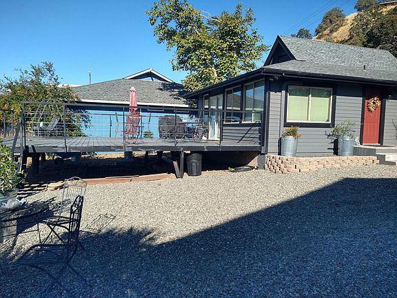 Full view of the house deck with patio furniture and Weber gas barbque