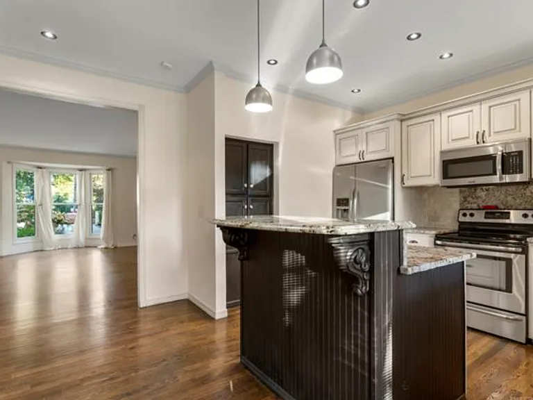 The kitchen is on the entry level, with bar-height seating for two and a pantry. All appliances, including the refrigerator, stay.