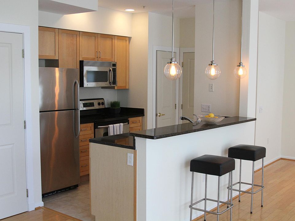 View of the kitchen area. Stainless steel appliances. Refrigerator with filtered water and ice machine in freezer. More cabinets, large pantry, and additional utility and storage closet. Bar stools are available for your use, if interested.