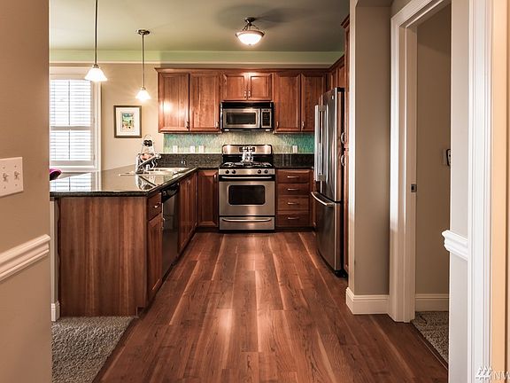 Great lighting, beautiful cherry cabinets, granite counter tops, granite backsplash and all appliances stay!