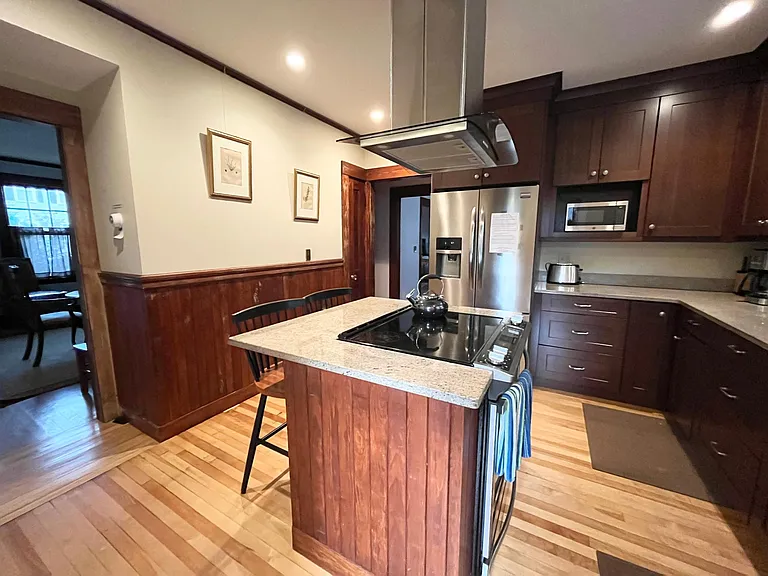 Modern kitchen with SS appliances and granite counter tops.