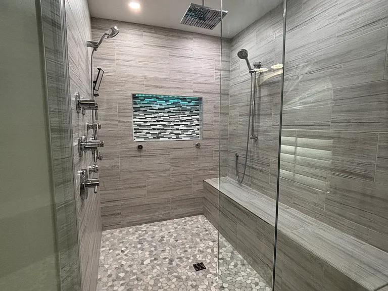 Master bath shower with rainfall shower head, dual shower heads, and body sprayers