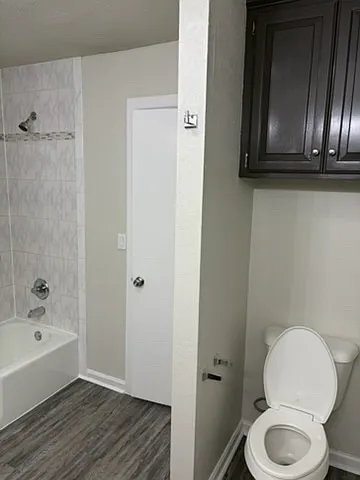 View of master bathroom with toilet.