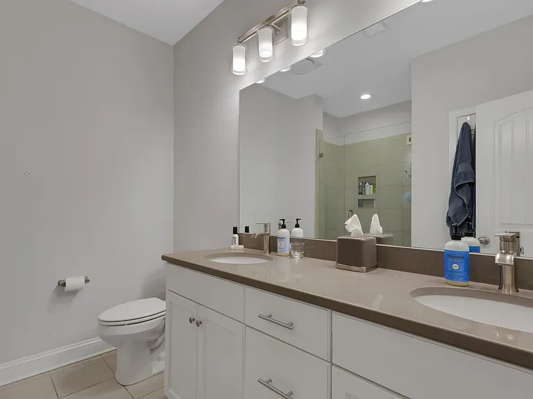 Primary ensuite with double vanities, quartz countertops, walk-in tile shower!