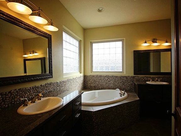 Master bathroom with garden tub, dual vanities, and separate