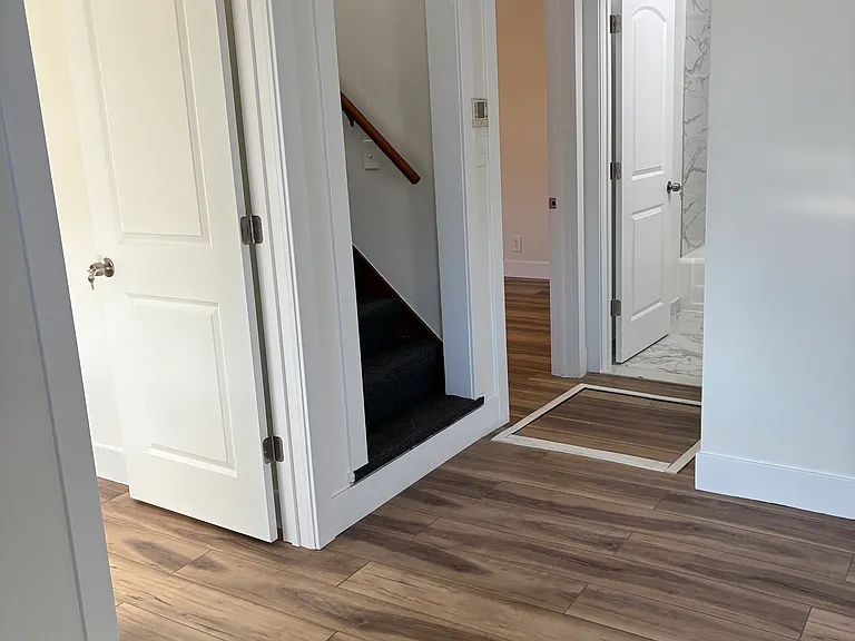 Two bedrooms & bathroom off the living room. Stairs lead to 1 large bedroom & 1 smaller sized bedroom.