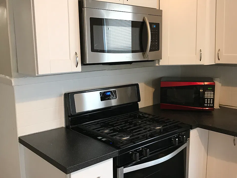 Modern kitchen with cooking area adjacent to eat-in dining area