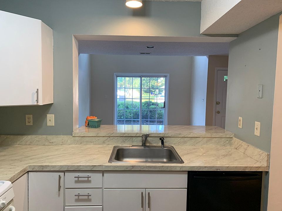 Kitchen can have a small bistro table counter top for stools looks out to living room to patio
