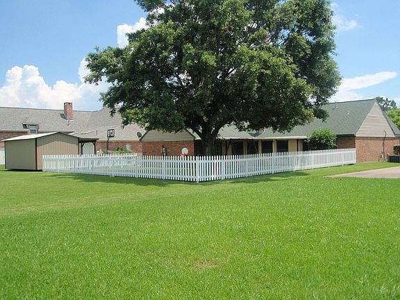 Large back yard with picket fence