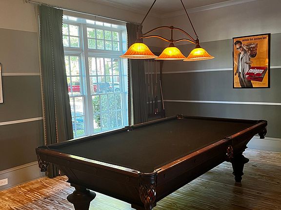Dining room, could seat 12, currently housing a full-sized pool table