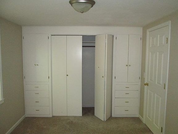 Bedroom with built-in closet and draweres