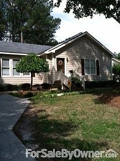 Front-side view of property
						:
						Beautiful trees line driveway.