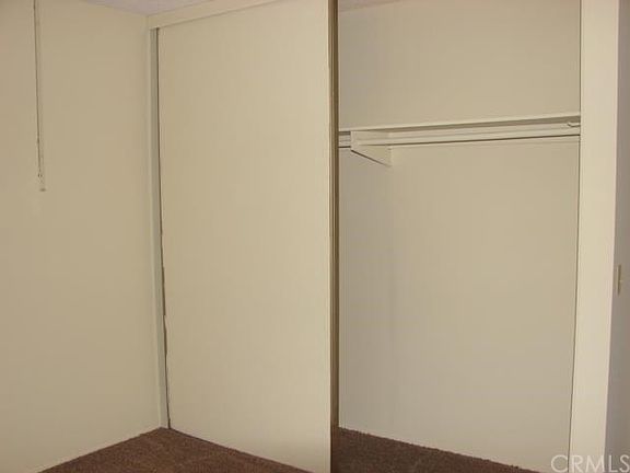 GUEST BEDROOM HAS FULL WALL CLOSET. PERFECT AREA FOR COMPUTER DESK.