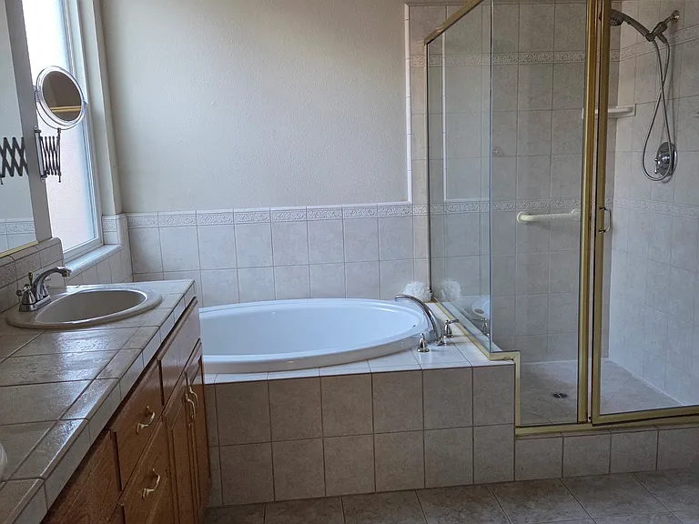 Master bathroom with lots of storage, soaking tub, separate shower
