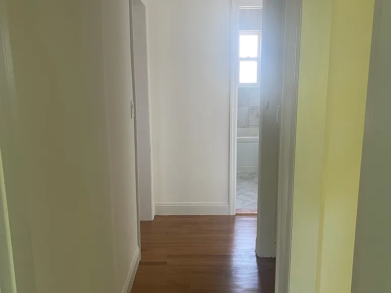Hallway with little laundry closet on the right side