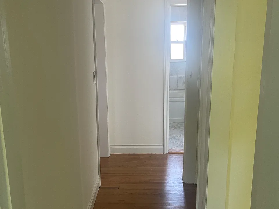 Hallway with little laundry closet on the right side