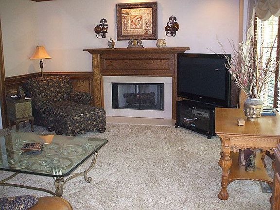 Large den with custom wood paneling, new carpet, fireplace