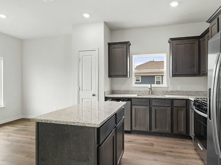 The kitchen has sprawling granite countertops.