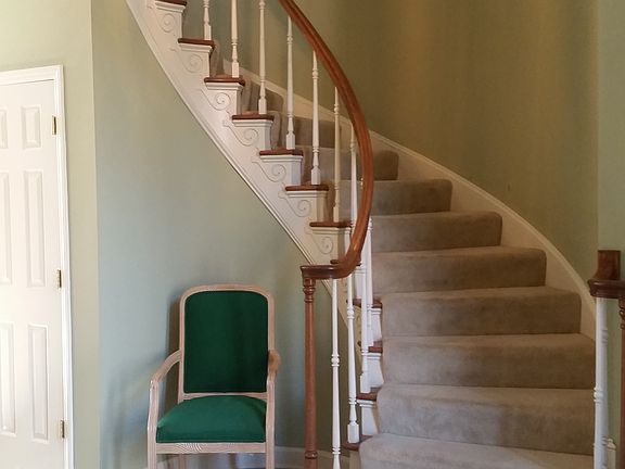 spiral staircase entryway with marble floors