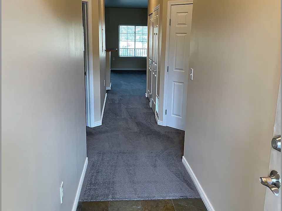 Entry way in from front door. Bedrooms are on either side past first entry wall with living/dining area and kitchen at the back. No carpet, floors are now wood.