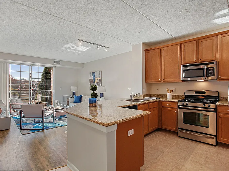 Open-concept kitchen with bar seating and stainless steel appliances
