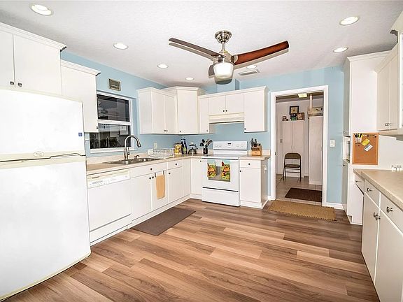 Kitchen - new laminate flooring, white cabinetry, electric stove, microwave, dishwasher, refrigerator. _ 17 X 22