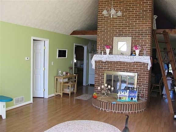 Faboulous masonry Fireplace divides living room from diningroom 