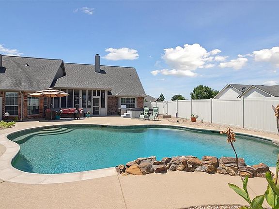 Sparkling saltwater pool with rock waterfall & stunning deck