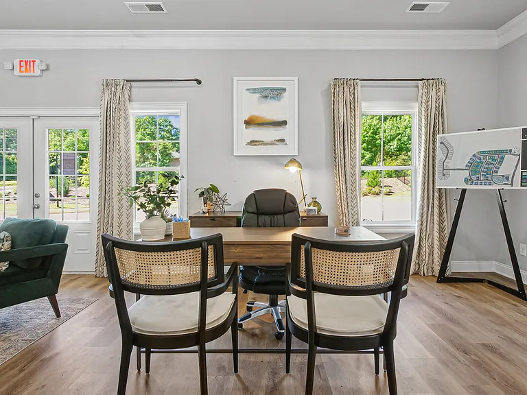 Clubhouse interior with leasing desk and relaxing sitting area.