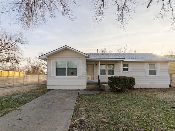 Front of Home - there is a two car attached garage on the side of this cute home!  Fresh paint and roof (3+ months). It doesn't look like it from the front, but this home is 1588 square feet, more or less!  Four beds, 2 1/2 baths, and two living areas!  N