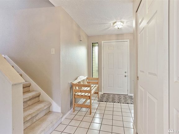 A spacious bright entry with room for seating and extra wide coat/storage closet