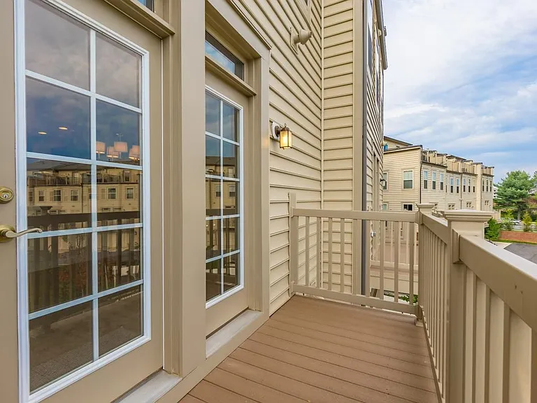 Trex-plank balcony 12' x 5' at outside of dining area over seeing green space on 2nd floor