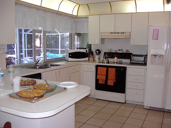 Lovely tiled open kitchen with eat in bar