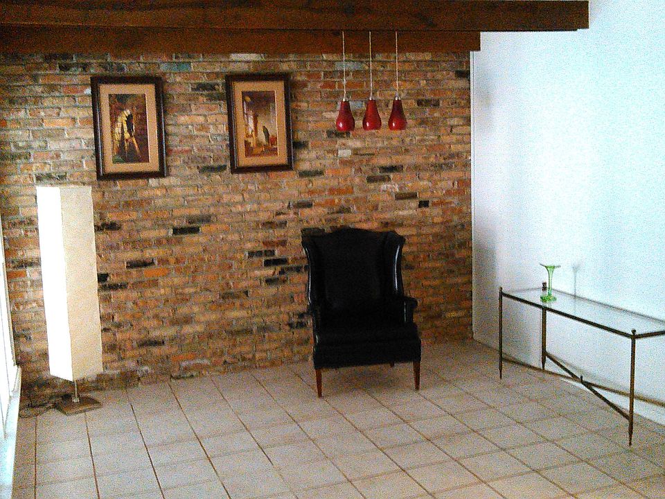 Living Room with Brick Accent Wall and Exposed Beams