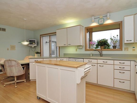 Spacious eat in kitchen. Newer Corian counter tops and appliances.