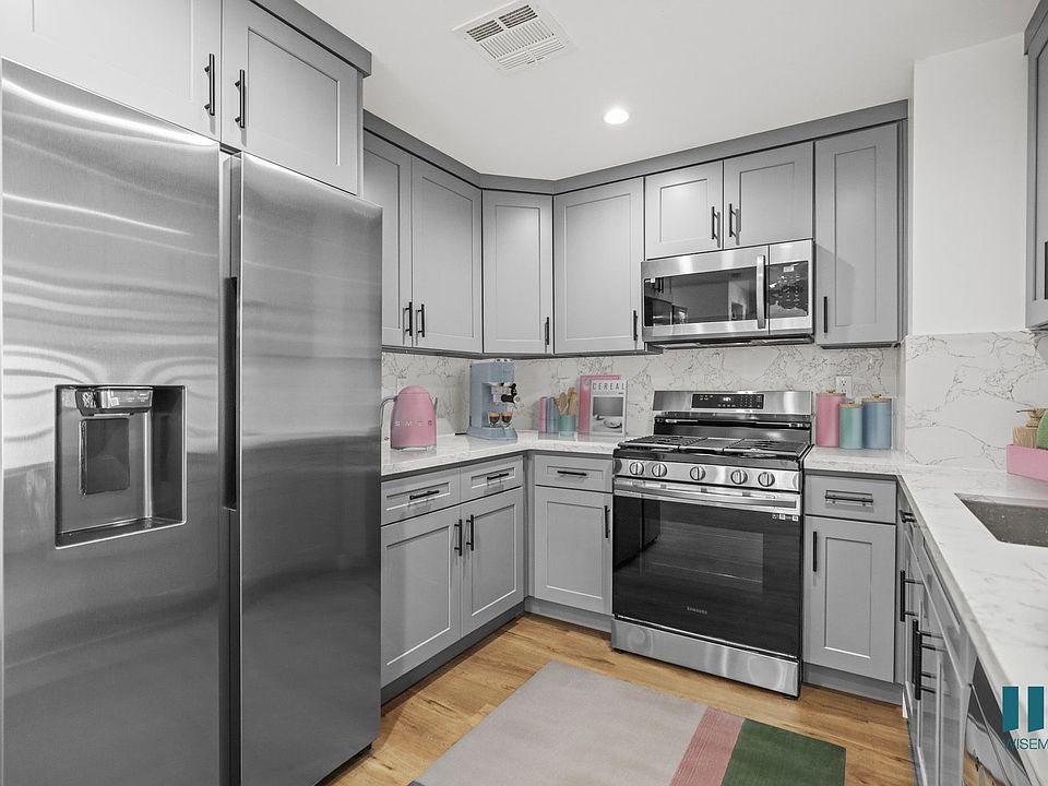 Kitchen with Stainless-Steel Refrigerator, Stove, Microwave Oven, and Dishwasher