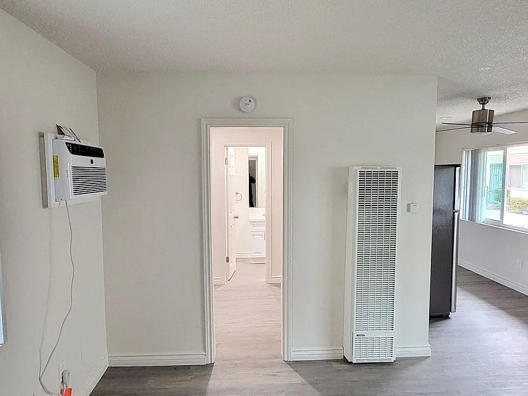 Living room looking towards dressing room and bathroom at Orlando Woods Apartments in El Cajon, California.