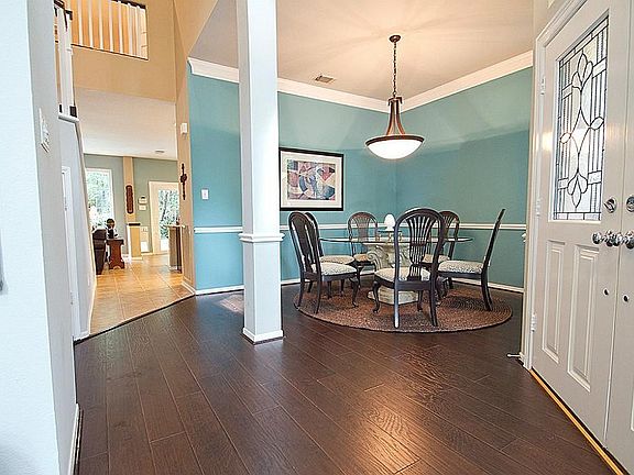 As you enter the home, you'll find soaring ceilings with new flooring added in 10/14 to the formal dining and formal living areas.