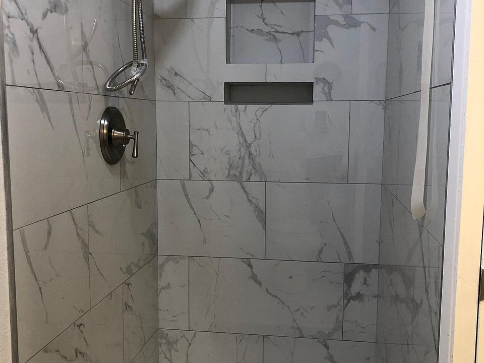 Newly tiled shower stall in master bathroom