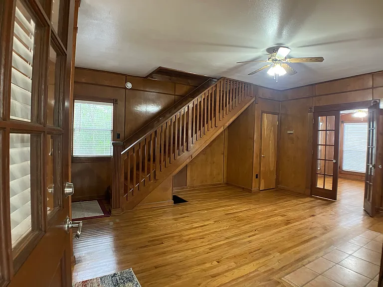 Living Room with Stairs, view into Library