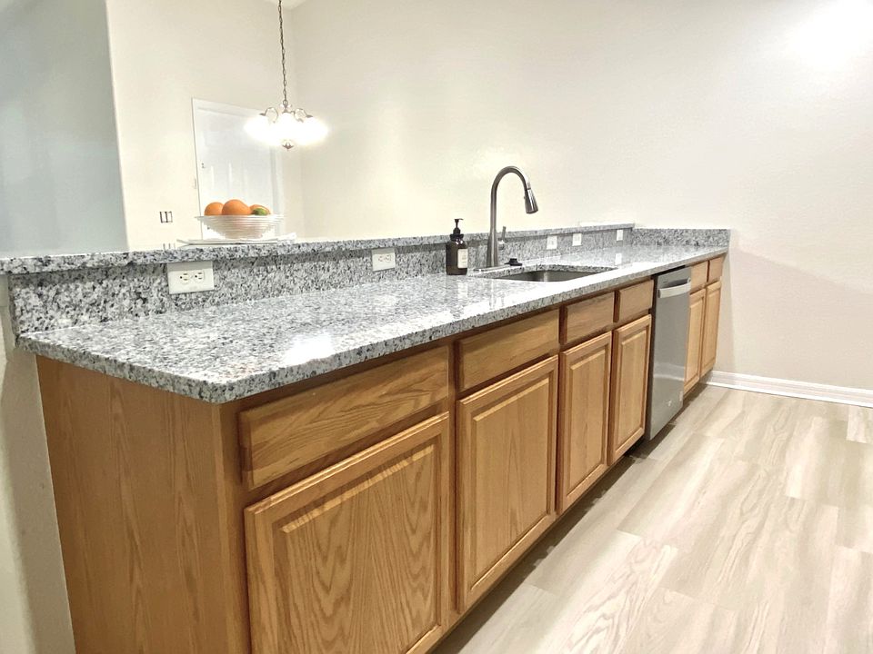 New hardware, farmhouse style kitchen sink, and granite counter top