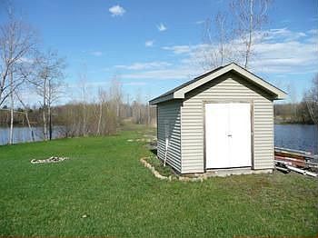 Nice shed in the backyard is perfect for all the yard equipment or toys!