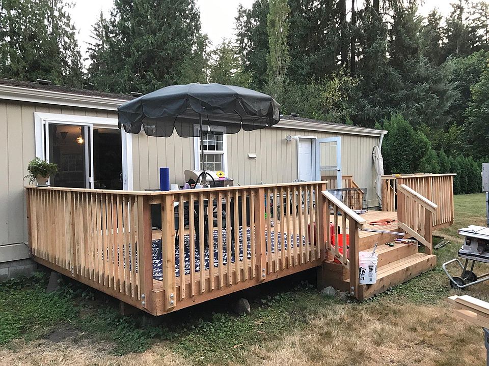 BACK DECK WITH SLIDER TO DINING ROOM / ALSO HAS SEPARATE BACK DOOR ON THE RIGHT TO MUD/ LAUNDRY ROOM
